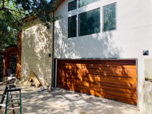 Fratex wooden garage door on white house